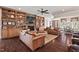 Cozy living room with built-in shelving, a stone fireplace, and comfortable leather seating, creating an inviting atmosphere at 2633 Beckwith Rd, Apex, NC 27523