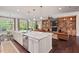 Open-concept living area with a modern kitchen, a cozy living room, and a charming breakfast nook with natural light at 2633 Beckwith Rd, Apex, NC 27523