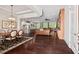 Open-concept living space with hardwood floors connecting a dining area, kitchen, and living room at 2633 Beckwith Rd, Apex, NC 27523