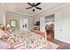 The primary bedroom features a tray ceiling and adjoins the ensuite bathroom and kitchen area at 2633 Beckwith Rd, Apex, NC 27523