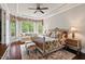 The primary bedroom features a tray ceiling, large windows, and a sitting area with natural light at 2633 Beckwith Rd, Apex, NC 27523
