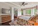 The primary bedroom features a tray ceiling, large windows, and built in storage at 2633 Beckwith Rd, Apex, NC 27523