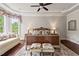 The primary bedroom features a tray ceiling, large windows, and a sitting area for relaxing at 2633 Beckwith Rd, Apex, NC 27523