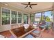 This screened porch offers an open view of the house and a glass-topped table for outdoor dining at 2633 Beckwith Rd, Apex, NC 27523