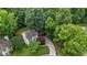 Aerial view of home surrounded by lush trees, and a long driveway at 2705 Kempsford Pl, Raleigh, NC 27604
