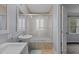 Bathroom with pebble shower floor, shower doors, and pedestal sink at 2705 Kempsford Pl, Raleigh, NC 27604