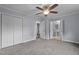Spacious bedroom with carpet, a ceiling fan, and two large closets at 2705 Kempsford Pl, Raleigh, NC 27604