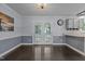 Well-lit dining room with french doors and hardwood floors, connecting to the kitchen at 2705 Kempsford Pl, Raleigh, NC 27604