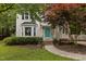 Charming two-story home featuring a bright teal door and beautifully landscaped front yard at 2705 Kempsford Pl, Raleigh, NC 27604
