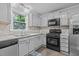 Efficient kitchen featuring stainless steel appliances, gas range, and stylish backsplash at 2705 Kempsford Pl, Raleigh, NC 27604