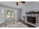 Cozy living room with a bay window, decorative fireplace, and hardwood floors at 2705 Kempsford Pl, Raleigh, NC 27604