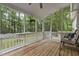 Inviting screened porch with wooden floors, ceiling fan, and peaceful backyard view at 2705 Kempsford Pl, Raleigh, NC 27604