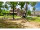 Large backyard with mature trees, brick home, in-ground pool and swing set at 2912 Turning Brook Ln, Raleigh, NC 27616