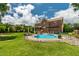 Backyard view of in-ground pool with tanning deck and patio area with pergola and screened porch at 2912 Turning Brook Ln, Raleigh, NC 27616