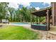 Inviting backyard featuring a pool, lush green lawn, pergola, and comfortable outdoor seating at 2912 Turning Brook Ln, Raleigh, NC 27616