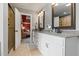 Bathroom vanity featuring double sinks, modern fixtures, and tile floors at 2912 Turning Brook Ln, Raleigh, NC 27616