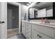 Bathroom featuring a double vanity with granite counters and white cabinets at 2912 Turning Brook Ln, Raleigh, NC 27616