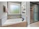 Bright bathroom boasting a soaking tub, mosaic tile, and separate shower at 2912 Turning Brook Ln, Raleigh, NC 27616