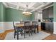 Stylish dining room with table, chairs, and view of the kitchen and coffered ceilings at 2912 Turning Brook Ln, Raleigh, NC 27616