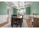Bright dining room with hardwood floors, a neutral rug, coffered ceiling, and an open view to the home's entrance at 2912 Turning Brook Ln, Raleigh, NC 27616