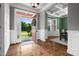 Inviting foyer with wood floors, gray walls, and an entry to the dining room with coffered ceilings and a bay window at 2912 Turning Brook Ln, Raleigh, NC 27616