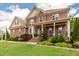Beautiful brick two-story home with red shutters, covered front porch, and manicured landscaping at 2912 Turning Brook Ln, Raleigh, NC 27616