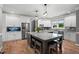Open concept kitchen with a large island, stainless steel appliances, white cabinetry, and hardwood floors at 2912 Turning Brook Ln, Raleigh, NC 27616