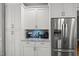 Kitchenette features granite counters, stainless steel refrigerator, and modern cabinetry at 2912 Turning Brook Ln, Raleigh, NC 27616