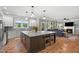 Spacious kitchen with large island, pendant lights, hardwood floors, and open to the living area with a fireplace at 2912 Turning Brook Ln, Raleigh, NC 27616