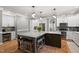 Spacious kitchen island features granite counters, seating, and ample storage at 2912 Turning Brook Ln, Raleigh, NC 27616