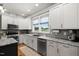 Bright kitchen features granite countertops, stainless steel appliances, and ample cabinet space at 2912 Turning Brook Ln, Raleigh, NC 27616
