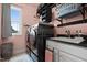 Modern laundry room features a black washer and dryer set, sink, and shelving at 2912 Turning Brook Ln, Raleigh, NC 27616