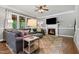 Cozy living room featuring a fireplace, large windows, and comfortable seating at 2912 Turning Brook Ln, Raleigh, NC 27616