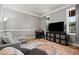 Bright living room with hardwood floors, neutral walls, a large television, and a comfortable sofa at 2912 Turning Brook Ln, Raleigh, NC 27616
