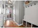 Hallway mudroom featuring a coat rack with bench, storage baskets, and wood floors at 2912 Turning Brook Ln, Raleigh, NC 27616