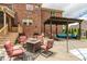 Outdoor patio featuring an in-ground pool, outdoor seating, and well-maintained landscaping at 2912 Turning Brook Ln, Raleigh, NC 27616