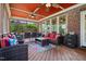 Covered porch with wood flooring, fan and comfortable seating at 2912 Turning Brook Ln, Raleigh, NC 27616