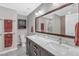 Bathroom with dual vanity with white countertop, dark cabinets, and well lit with neutral walls at 303 Leighann Ridge Ln, Rolesville, NC 27571
