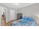Cheerful bedroom boasts hardwood floors, comfortable bed, and natural light for a warm and inviting atmosphere at 303 Leighann Ridge Ln, Rolesville, NC 27571