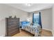 Bright bedroom with hardwood floors, blue accents, and playful decor creates a cheerful and inviting space at 303 Leighann Ridge Ln, Rolesville, NC 27571