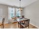 Dining room with a modern chandelier and large window for natural light at 303 Leighann Ridge Ln, Rolesville, NC 27571