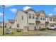 Townhome showcasing attached garage and neat front lawn on a sunny day at 303 Leighann Ridge Ln, Rolesville, NC 27571