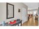 Entryway with a dark wood table, mirror, vase and hardwood floors at 303 Leighann Ridge Ln, Rolesville, NC 27571