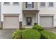 Close-up of townhome entrance with manicured bushes and inviting front door at 303 Leighann Ridge Ln, Rolesville, NC 27571
