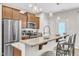 Stylish kitchen boasts a granite-topped island with bar seating and stainless steel appliances at 303 Leighann Ridge Ln, Rolesville, NC 27571