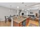 Open-concept kitchen with a granite-topped breakfast bar and a view into the living area at 303 Leighann Ridge Ln, Rolesville, NC 27571