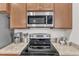 Close-up shot of a well-equipped kitchen featuring stainless steel appliances and granite countertops at 303 Leighann Ridge Ln, Rolesville, NC 27571