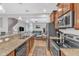Modern kitchen features granite countertops, stainless steel appliances, and an open design leading into the living area at 303 Leighann Ridge Ln, Rolesville, NC 27571