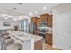 Bright kitchen featuring a breakfast bar with seating, stainless steel appliances, and warm wood cabinetry at 303 Leighann Ridge Ln, Rolesville, NC 27571