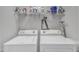 Laundry room with white washer and dryer and shelf above for storage and easy access at 303 Leighann Ridge Ln, Rolesville, NC 27571